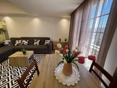a living room with a vase of flowers on a table at Cozy One bedroom old town tawaya Sahel hashish in Hurghada