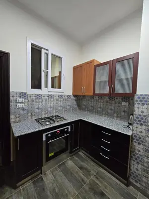 a kitchen with a stove and a counter top at مصر in Hurghada