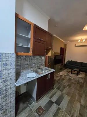 an empty kitchen with a sink and a living room at مصر in Hurghada