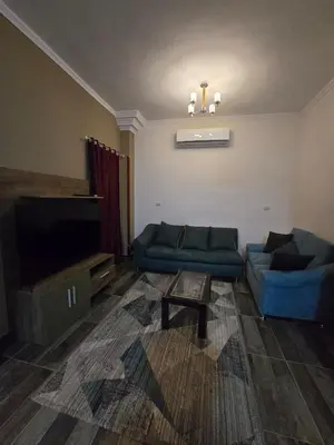 a living room with two couches and a flat screen tv at مصر in Hurghada