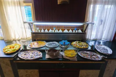 a table with many plates of food on it at Geisum beach hotel in Hurghada