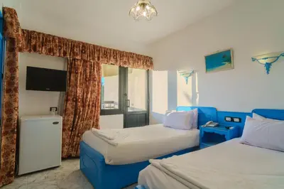 a hotel room with two beds and a window at Geisum beach hotel in Hurghada