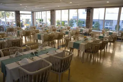 a banquet hall with tables and chairs with green tablecloths at Fanadir Bay in Hurghada