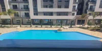 an empty swimming pool in front of a building at Fanadir Bay in Hurghada