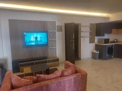 a living room with a couch and a television at Fanadir Bay in Hurghada