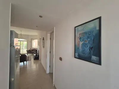 a living room with a painting on a wall at K31 Peaceful 2 Bedrooms Nile Resort Flat in Luxor in Luxor