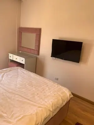 a bedroom with a bed and a flat screen tv at for the best all-rounder sea view Hurghada Apartment&DownTown AlDau in Banī Ghālib