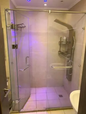 a bathroom with a glass shower with purple lights at for the best all-rounder sea view Hurghada Apartment&DownTown AlDau in Banī Ghālib