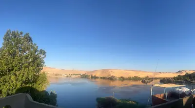 a view of a river with a boat on it at Aswan Holistic Hotel in Aswan
