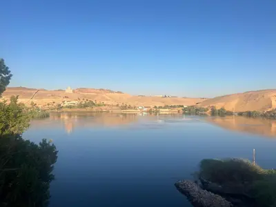 a large body of water with mountains in the background at Aswan Holistic Hotel in Aswan