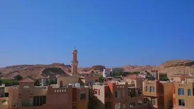 a city with buildings and a clock tower in the distance at Aldau Heights Hurghada in Hurghada