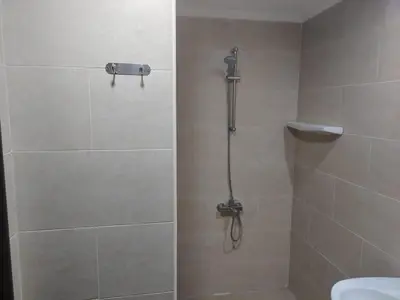 a bathroom with a shower with a shower head at Aldau Heights Hurghada in Hurghada