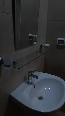 a bathroom with a white sink and a mirror at Aldau Heights Hurghada in Hurghada