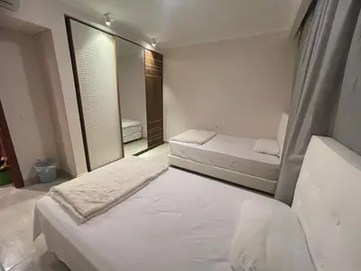 a bedroom with two beds and a mirror at Special Apartment For Rent 103 in Hurghada