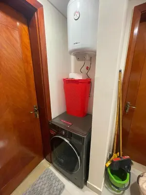 a washing machine in a room next to a door at Special Apartment For Rent 103 in Hurghada