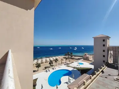a view of the beach from the balcony of a resort at Special Apartment For Rent 103 in Hurghada
