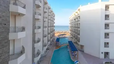 a view of a swimming pool between two buildings at Hurghada Sea view with pool in Hurghada
