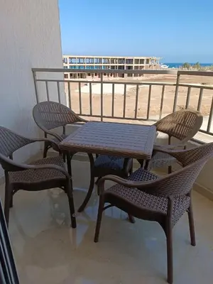 a table and chairs on a balcony with the beach at Hurghada Sea view with pool in Hurghada