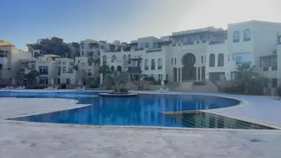 a large swimming pool in front of a building at Azzurra villa in Hurghada
