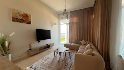 a living room with a couch and a tv at Azzurra villa in Hurghada