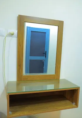a mirror sitting on top of a wooden shelf at Aswan City Star in Aswan