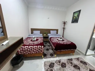 two beds sitting next to each other in a room at Aswan City Star in Aswan