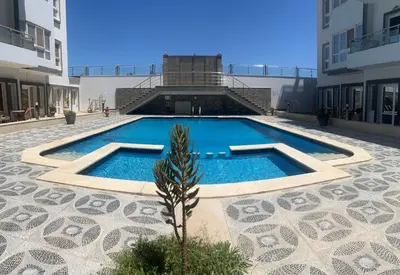 a swimming pool in the middle of a building at Magawish resort in Hurghada