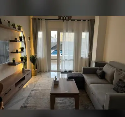 a living room with a couch and a coffee table at Magawish resort in Hurghada