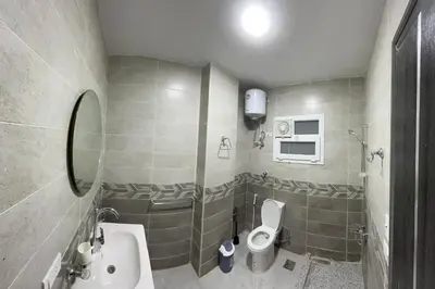 a small bathroom with a sink and a toilet at Magawish resort in Hurghada