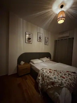 a bedroom with a bed and a light at Magawish resort in Hurghada