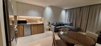 a living room with a couch and a table in a room at El Gouna Luxury 1BR Golf Apartment at Ancient Sands Resort Pool, Beach & Marina Access in Hurghada