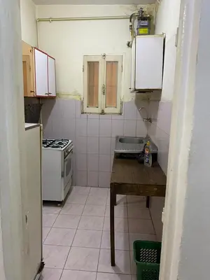 a small kitchen with a table and a stove at Nile Cruise Aswan in Luxor