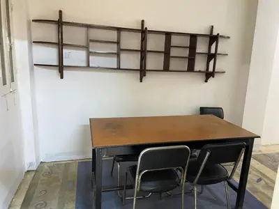 a table and chairs in a room with shelves at Nile Cruise Aswan in Luxor