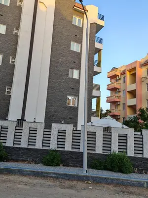 a building with a white fence in front of a building at THE BESt in Hurghada
