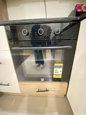 a black oven with a person standing inside of it at alkarma nubia apartment 1521 in Hurghada