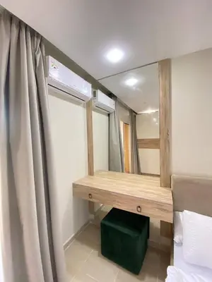 a bedroom with a vanity and a mirror and a window at alkarma nubia apartment 1521 in Hurghada