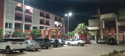 a row of cars parked in a parking lot at night at فندق ميريت امون سوهاج in Jazīrat Maḩrūs