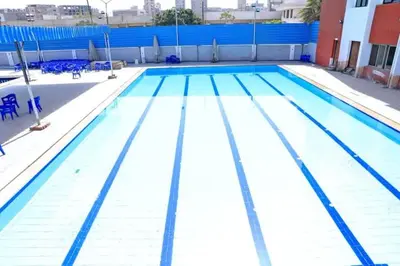 a large swimming pool with blue and white lanes at فندق ميريت امون سوهاج in Jazīrat Maḩrūs