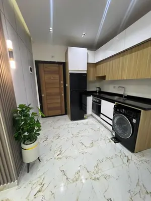 a kitchen with a marble floor and a dishwasher at La Bela Resort in Hurghada