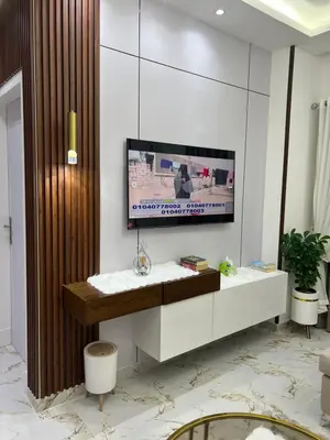 a living room with a tv on a wall at La Bela Resort in Hurghada