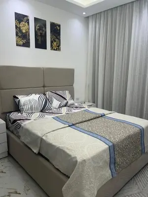a bedroom with a bed with two pillows on it at La Bela Resort in Hurghada