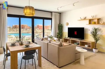 a living room with a couch and a table at The 2BDR Blue Horizon Kamaran El Gouna in Hurghada