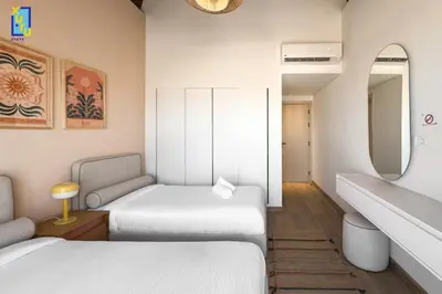 a hotel room with two beds and a mirror at The 2BDR Blue Horizon Kamaran El Gouna in Hurghada