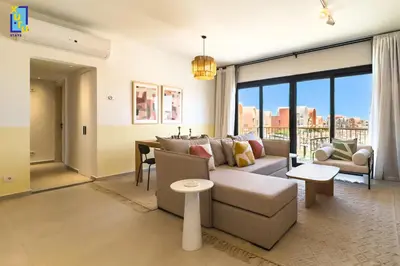 a living room with a couch and a table at The 2BDR Blue Horizon Kamaran El Gouna in Hurghada