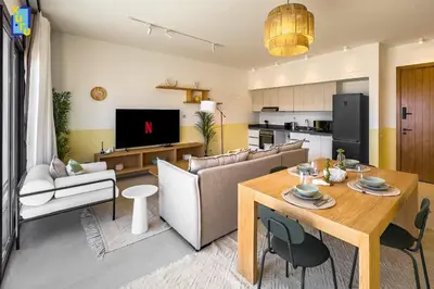 a living room with a table and a living room with a couch at The 2BDR Blue Horizon Kamaran El Gouna in Hurghada