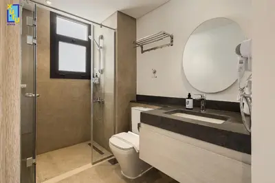 a bathroom with a sink and a mirror and a toilet at The 2BDR Blue Horizon Kamaran El Gouna in Hurghada