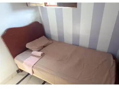 a small bed with a towel on it in a room at Safy Guest House in Aswan