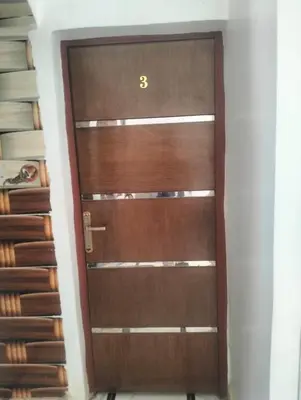 a wooden door with the number three on it at Safy Guest House in Aswan