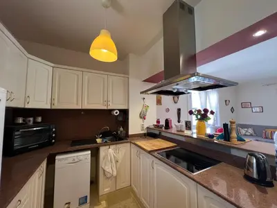 a kitchen with white cabinets and a stove top oven at Lagoon Charm | 1BR in Steigenberger El Gouna in Hurghada
