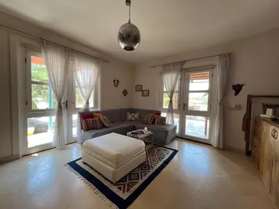 a living room with a couch and a table at Lagoon Charm | 1BR in Steigenberger El Gouna in Hurghada